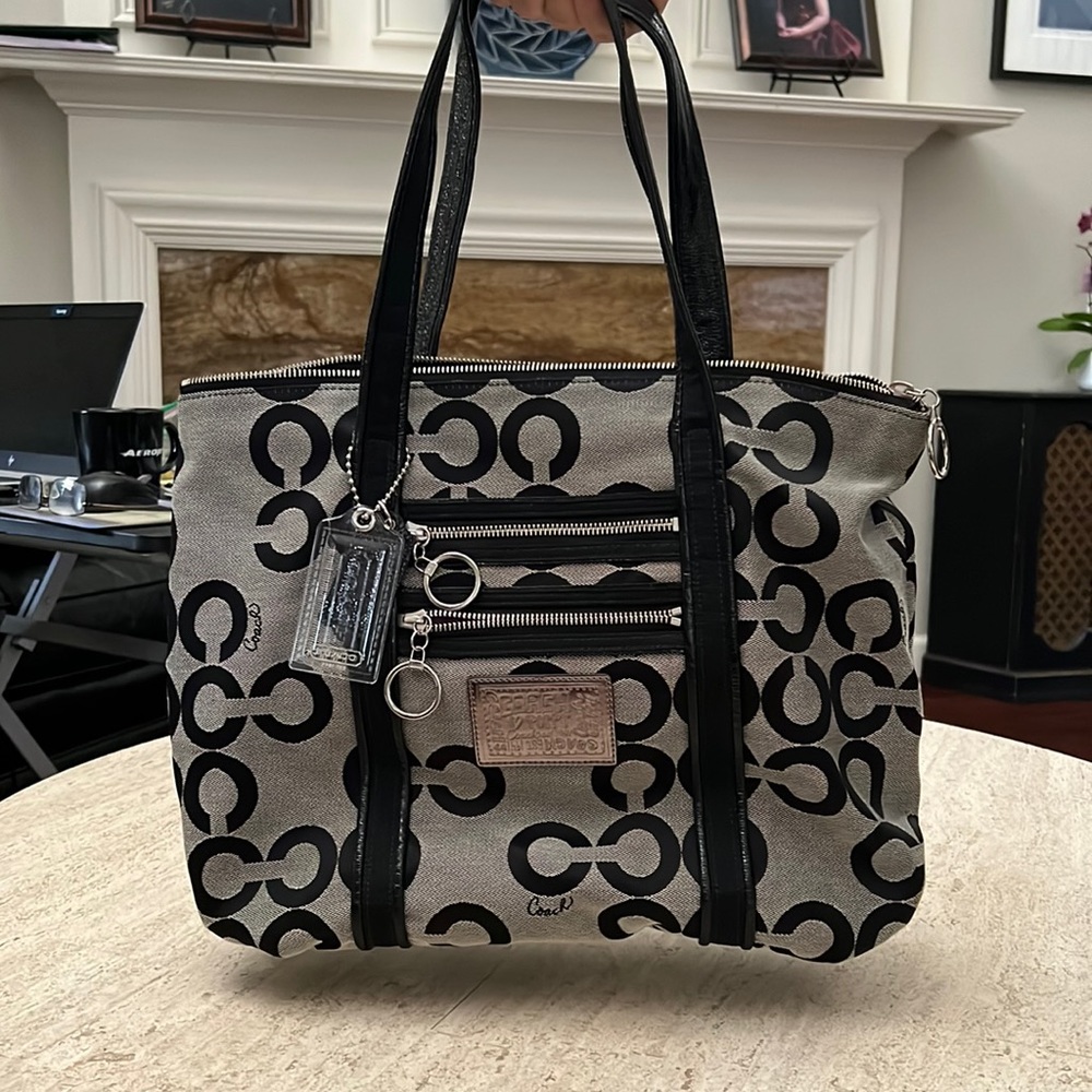 Silver and black coach shoulder bag with purple lining